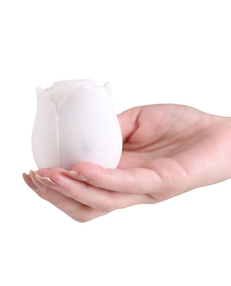 INYA The Vibrating Rose Massager Glow held in hand, showcasing its elegant rose shape and silicone material.