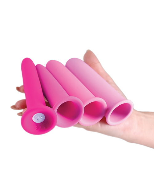 INYA Vibrating Gliders Silicone Anal Kit Pink displayed in hand, showcasing multiple smooth silicone pieces.