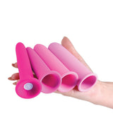 INYA Vibrating Gliders Silicone Anal Kit Pink displayed in hand, showcasing multiple smooth silicone pieces.