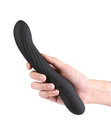 Renegade Wiggle Stick Silicone Gyrating Vibrator Black held in hand showcasing its sleek design and ribbed texture.