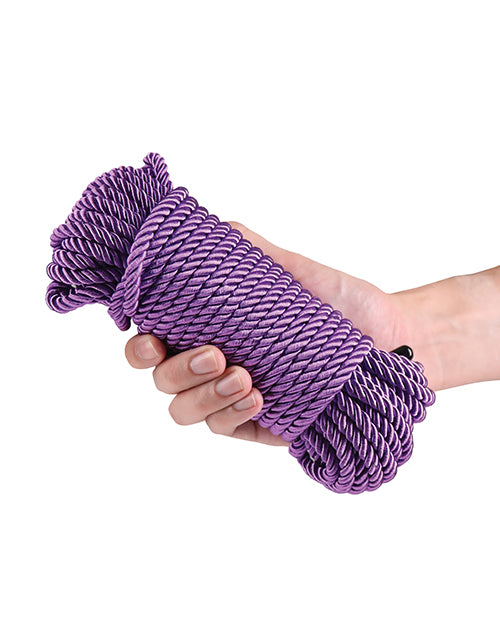 Bound 50 ft Bondage Restraints Rope Purple held in hand.