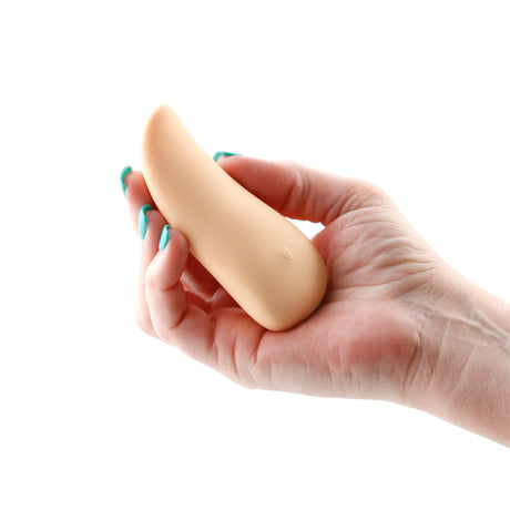 Desire Kama Vanilla Rechargeable Tongue Vibrator held in hand with a simple design for sensual stimulation.