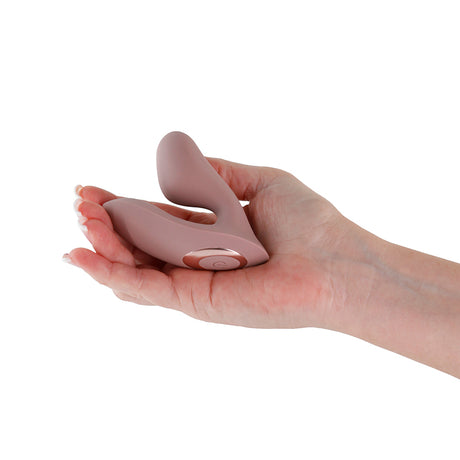 Desire Demure Autumn Wearable Dual Motor Vibrator held in a hand, showcasing its compact design and elegant curves.