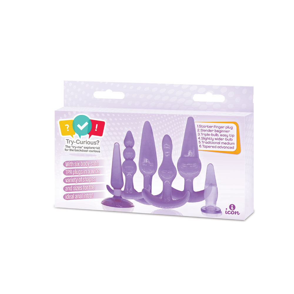 Try Curious 6 Piece Anal Plug Kit Purple displayed in packaging with various sizes and shapes for backdoor exploration.