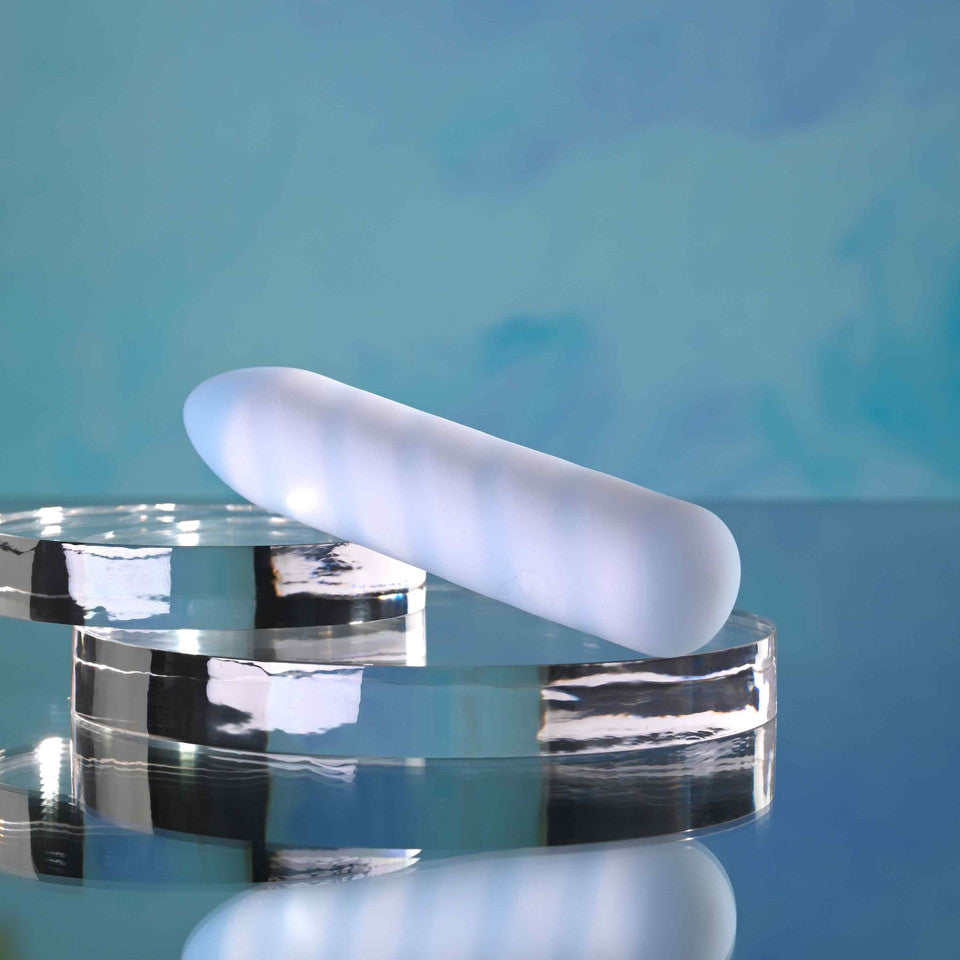 Playboy Unicorn Vibes Silicone Vibrating Bullet Blue on reflective surfaces with a blue background.