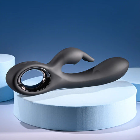 Playboy Late Night Bunny Silicone Rabbit Vibrator Black on blue background, showcasing its sleek design and dual stimulation features.