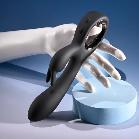 Playboy Late Night Bunny Silicone Rabbit Vibrator Black displayed on a hand with a blue background.