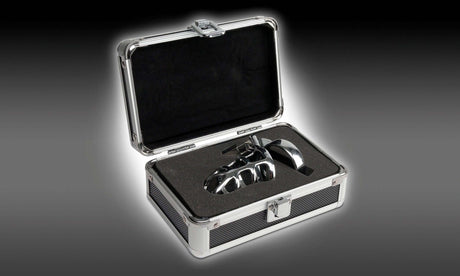 Pipedream Metal Worx Steel Cock Cage displayed in a sleek chrome case, showcasing luxury and elegance.