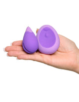 Fantasy For Her Remote Kegel Excite-Her Purple held in hand, highlighting its compact design for discreet use.