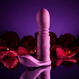 Playboy Match Play Silicone Dual Vibrator Purple placed among roses, showcasing its elegant design and versatility for intimate pleasure.