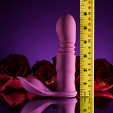 Playboy Match Play Silicone Dual Vibrator Purple alongside roses, highlighting its sleek design and versatility.