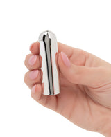 A hand holding the Turbo Buzz 10 Function Bullet Stimulator Silver, showcasing its compact and sleek design.