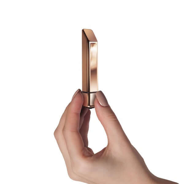 Rocks Off Bamboo 10 Speed Rose Gold Vibrator held elegantly, showcasing its sleek design and warm rose gold finish.