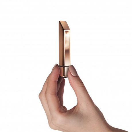 Rocks Off Bamboo 10 Speed Rose Gold Vibrator held elegantly, showcasing its sleek design and warm rose gold finish.