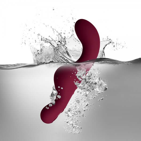Rocks Off Ruby Glow Dusk 10 Speed Ride On Vibrator splashing in water, showcasing its design and features.