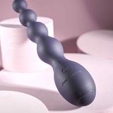 Zero Tolerance Rumpy Bumpy Silicone Anal Beads Purple close-up on a smooth surface with a pink background.