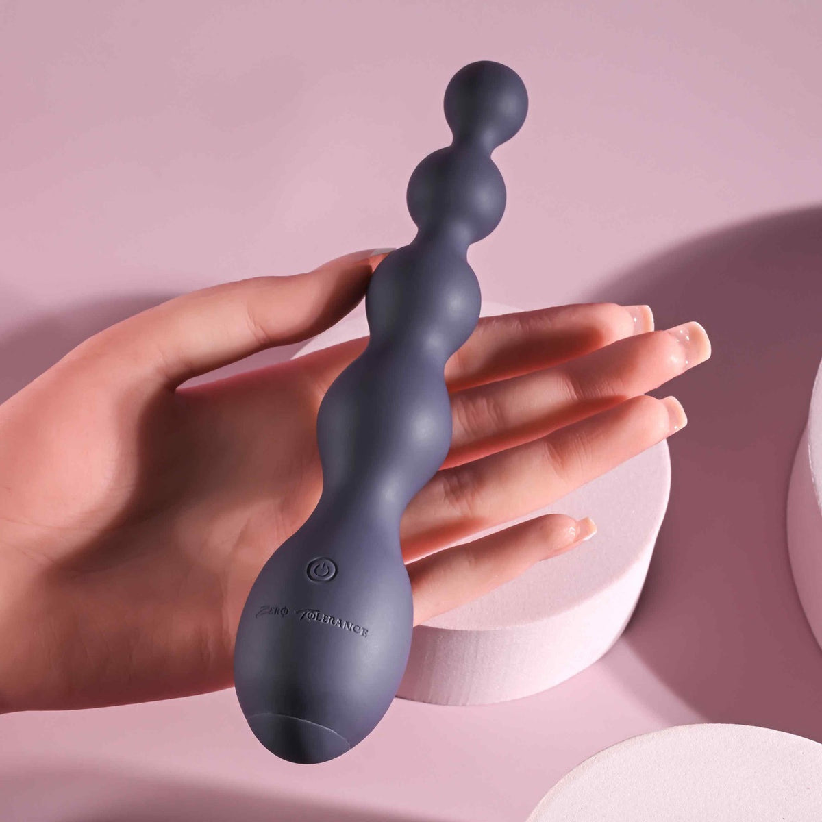 Zero Tolerance Rumpy Bumpy Silicone Anal Beads Purple held in a hand, showcasing its flexible design and graduated bulbs.