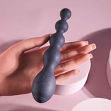 Zero Tolerance Rumpy Bumpy Silicone Anal Beads Purple held in a hand, showcasing its flexible design and graduated bulbs.