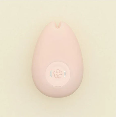 Tenga Iroha Sakura Silicone Clitoral Vibrator Pink on a soft background, showcasing its ergonomic design and button.