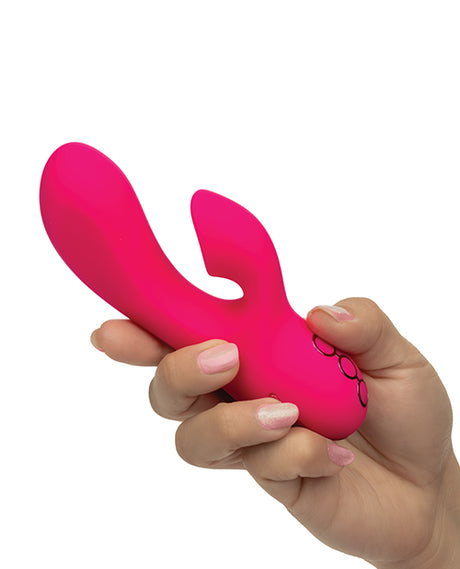 California Dreaming Venice Beach Babe Dual Vibrator held in hand, showcasing its sleek pink design.