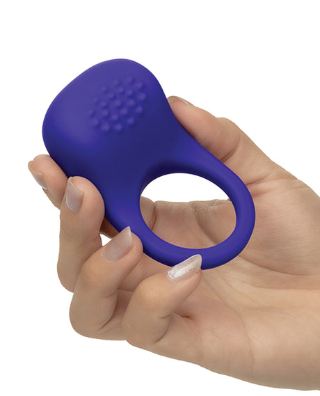 Rumbler Rumble Vibrating Ring Purple held in a hand showcasing its nubby texture and ergonomic design for enhanced pleasure.