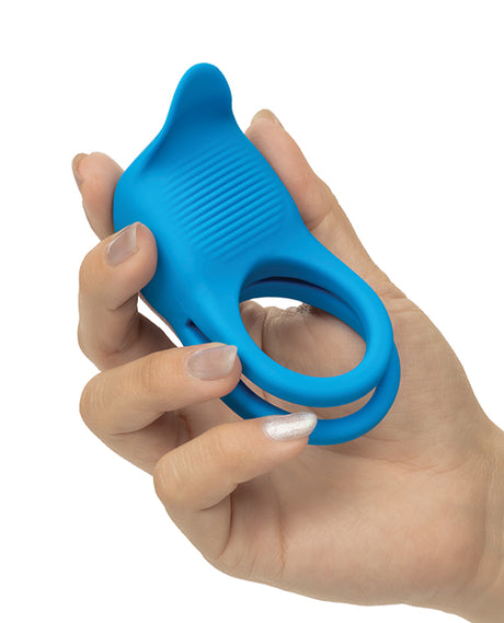 Rumbler Rumble Dual Vibrating Ring Blue held in hand, showcasing its dual-ring design and textured surface.
