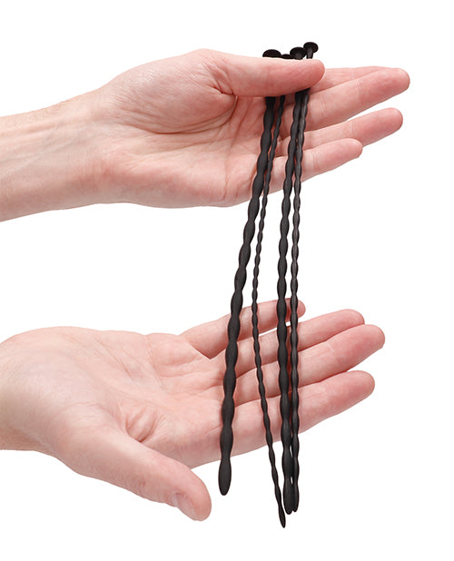 Spiral Screw Plug Set Beginner Urethral Sounding Black displayed in hands showing smooth design and texture.