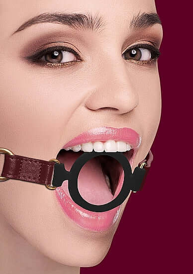 Model showcasing Ouch Halo Silicone Ring Gag Burgundy, featuring a black silicone ring and burgundy faux-leather straps.