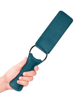 Shots Ouch Halo PU Leather Paddle Green held in hand, showcasing luxurious green finish and sleek design.