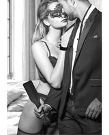 Ouch Black & White Introductory Bondage Kit 3 Black featuring a couple in a seductive pose with a mask and whip.