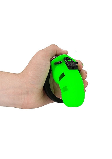 Ouch Model 20 Cock Cage 3.5 Inch Glow in the Dark Green held in hand, showcasing vibrant fluorescent design.