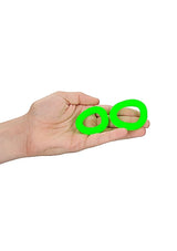 Glow 2pcs Cock Ring Set Glow In The Dark held in a hand, showcasing green luminous rings.