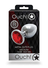Round Gem Butt Plug Medium Silver Ruby Red in packaging by Ouch!, featuring a sleek design with a jewel at the base.