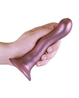 Shots Ouch 7 inch Curvy G-Spot Dildo Rose Gold held in a hand, showcasing its elegant design and soft silicone material.