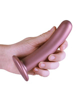 Shots Ouch 6 inch Smooth G-Spot Dildo Rose Gold held in a hand showcasing its sleek design and suction cup base.