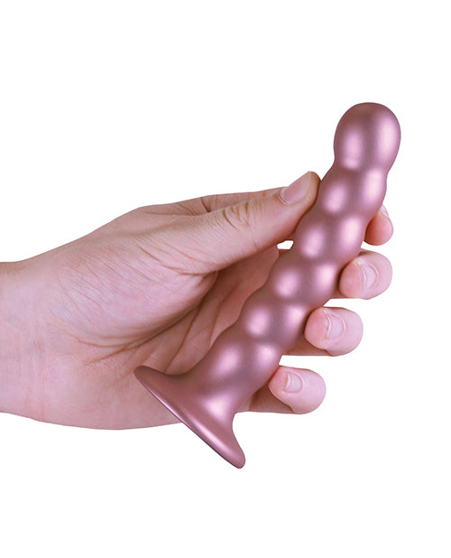Shots Ouch 5 inch Beaded G-Spot Dildo Rose Gold held in a hand, showcasing its elegant design.