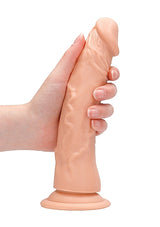 RealRock 8 Inch Realistic Suction Cup Dildo Flesh in hand showcasing its lifelike design and suction base.