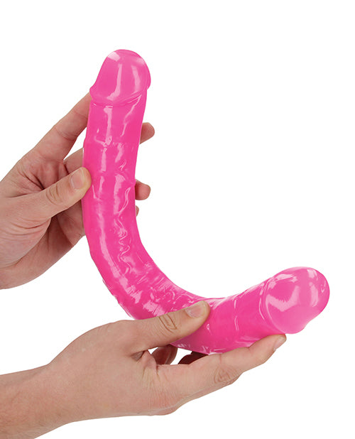 RealRock 15 inch Double Dong Glow in the Dark Neon Pink showcased in hands, highlighting its vivid design and versatile use.