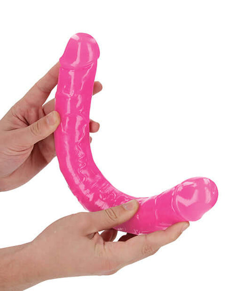 RealRock 15 inch Double Dong Glow in the Dark Neon Pink showcased in hands, highlighting its vivid design and versatile use.