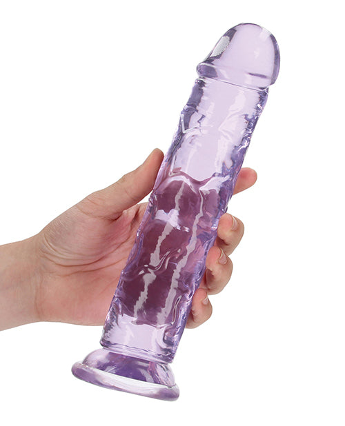 RealRock Crystal Clear 9 inch Dildo Suction Cup Purple held in hand, showcasing its clear design and smooth finish.