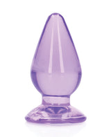 Shots RealRock Crystal Clear 4.5 inch Anal Plug Purple displaying a translucent purple design with a tapered tip and suction cup base.