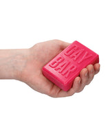 Hand holding Shots Gay Bar Novelty Soap Bar Pink with embossed text 'GAY BAR'.