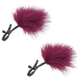S & M Enchanted Feather Nipple Clamps featuring soft maroon feathers and adjustable pressure clamps for sensation play.