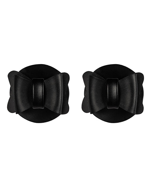 Sincerely Bow Tie Pasties Black Faux Leather in a stylish bow shape on a round background.