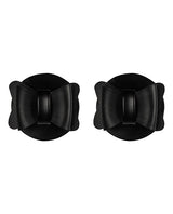 Sincerely Bow Tie Pasties Black Faux Leather in a stylish bow shape on a round background.