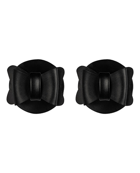 Sincerely Bow Tie Pasties Black Faux Leather in a stylish bow shape on a round background.