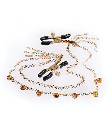 Sincerely Amber Chain Nipple Jewelry featuring elegant gold chain with beaded accents and black clamps.