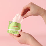 Hand holding Sweetums Watermelon Flavored Intimate Wipes packet with a wipe partially pulled out.