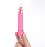 Maia Flora Fiercely Powerful Bullet Vibrator Pink in hand, showcasing clear tip with faux flowers and soft silicone shaft.