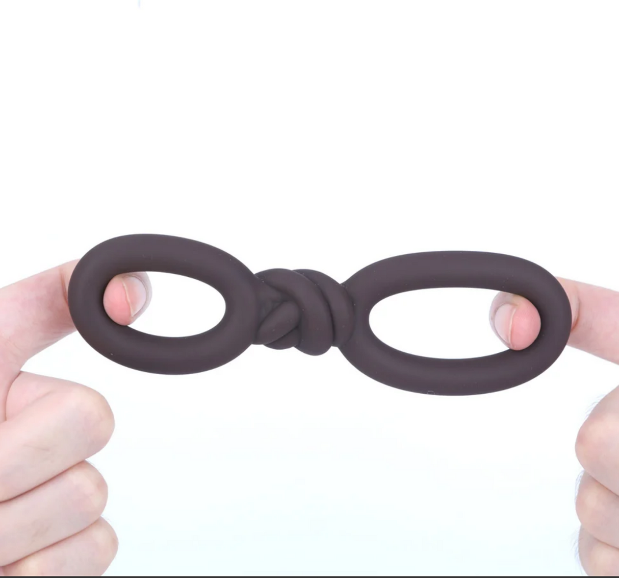 Maia Cooper Liquid Silicone Dual Super Stretch C-Ring Brown displayed in hands, showcasing its unique design and flexibility.